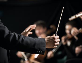 A conductor leads an orchestra