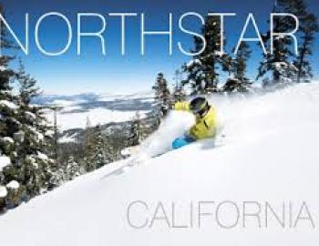 man skiing down hill in fresh powder on front of northstar magazine