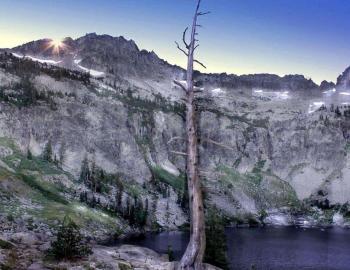 small alpine lake with granite mountain in the background