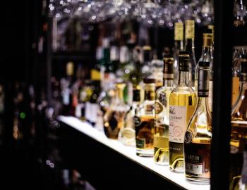 bottles of liquor on the back of a bar shelf