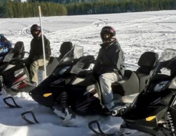 people on snowmobiles