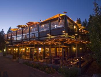 front of restaurant lit up at night