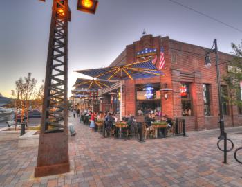 people eating outdoors at corner restaurant