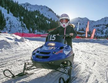 small snomobile with a child driving 