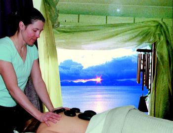 woman giving massage overlooking a lake view