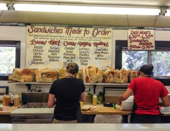 two people making sandwiches