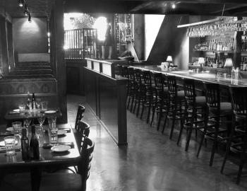 view of interior of restaurant wooden bar and tables