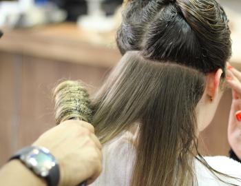 women having her hair brushed