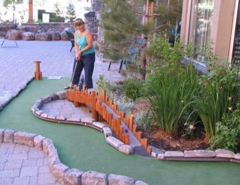 woman playing miniature golf