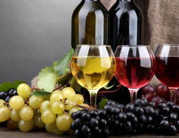 grapes and a glass of red wine and glass of white wine