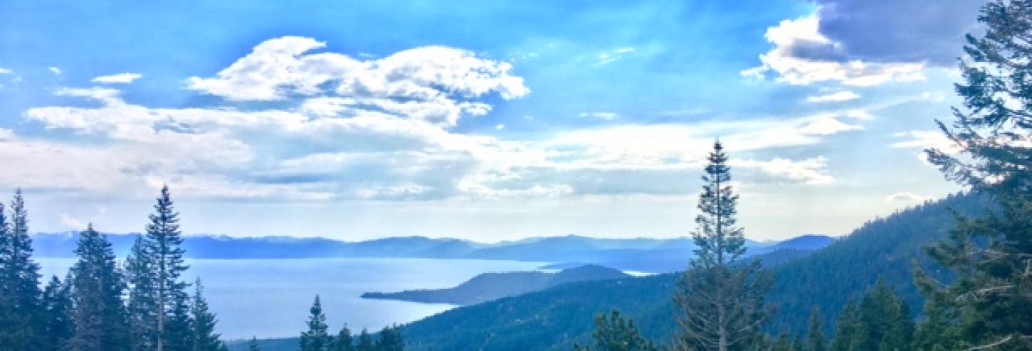 view of blue waters of tahoe with white clouds overhead 