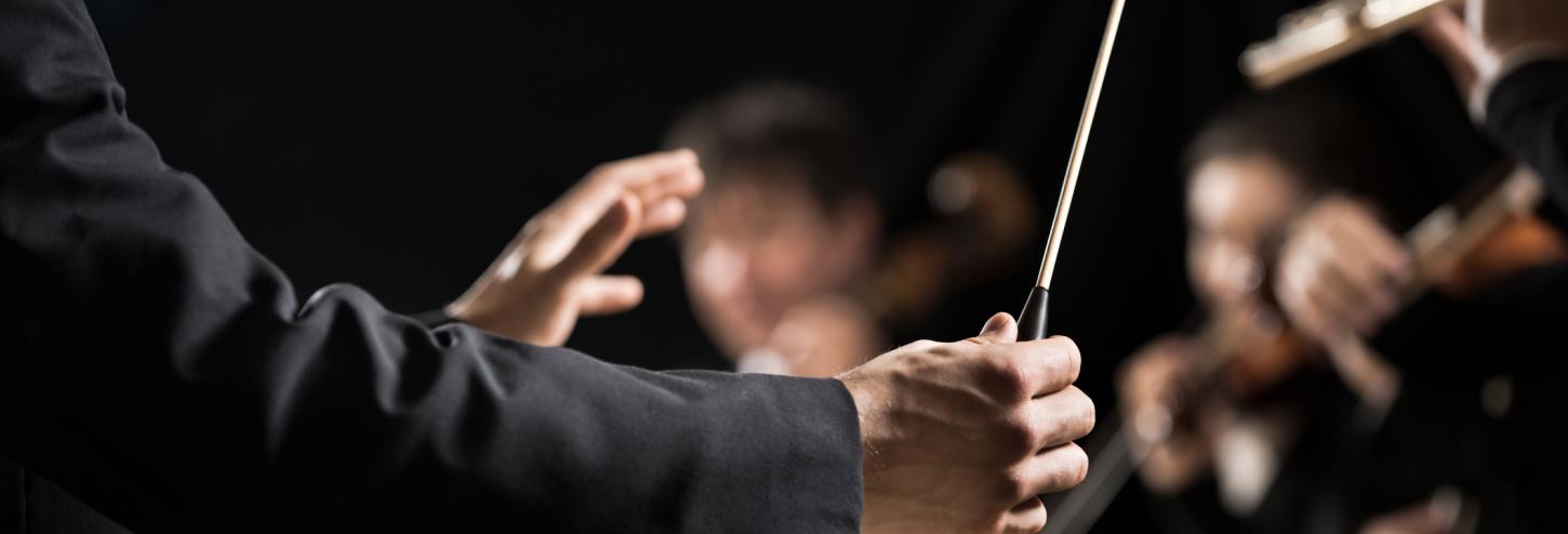 A conductor leads an orchestra