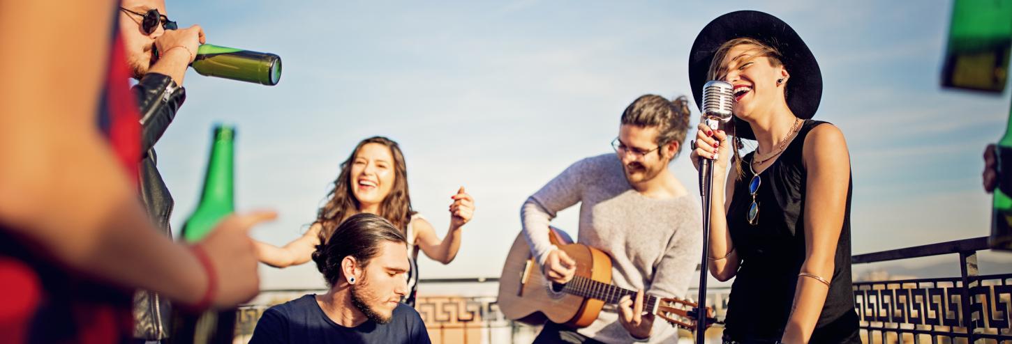 A group of people laugh and enjoy a festival 