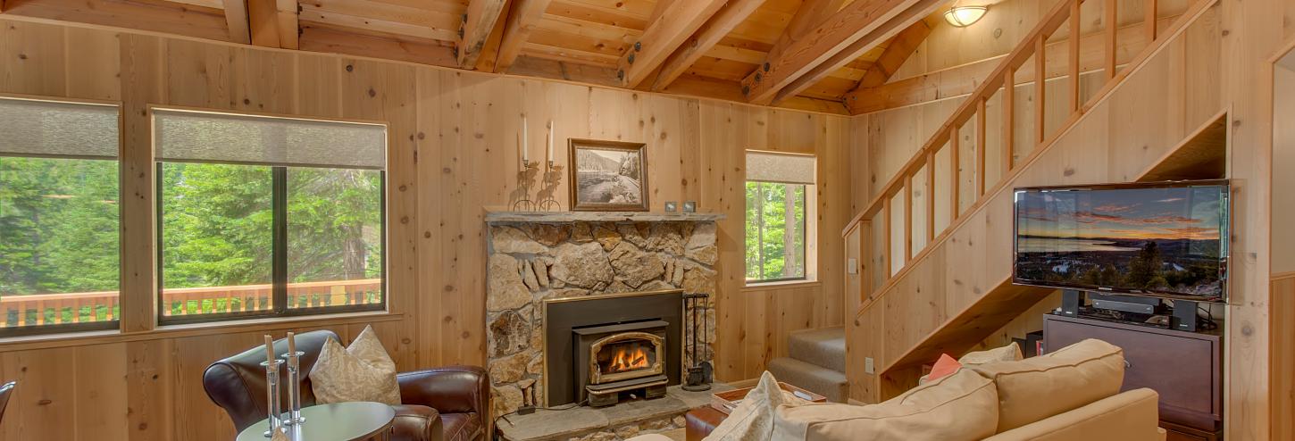 living room with rock fireplace 