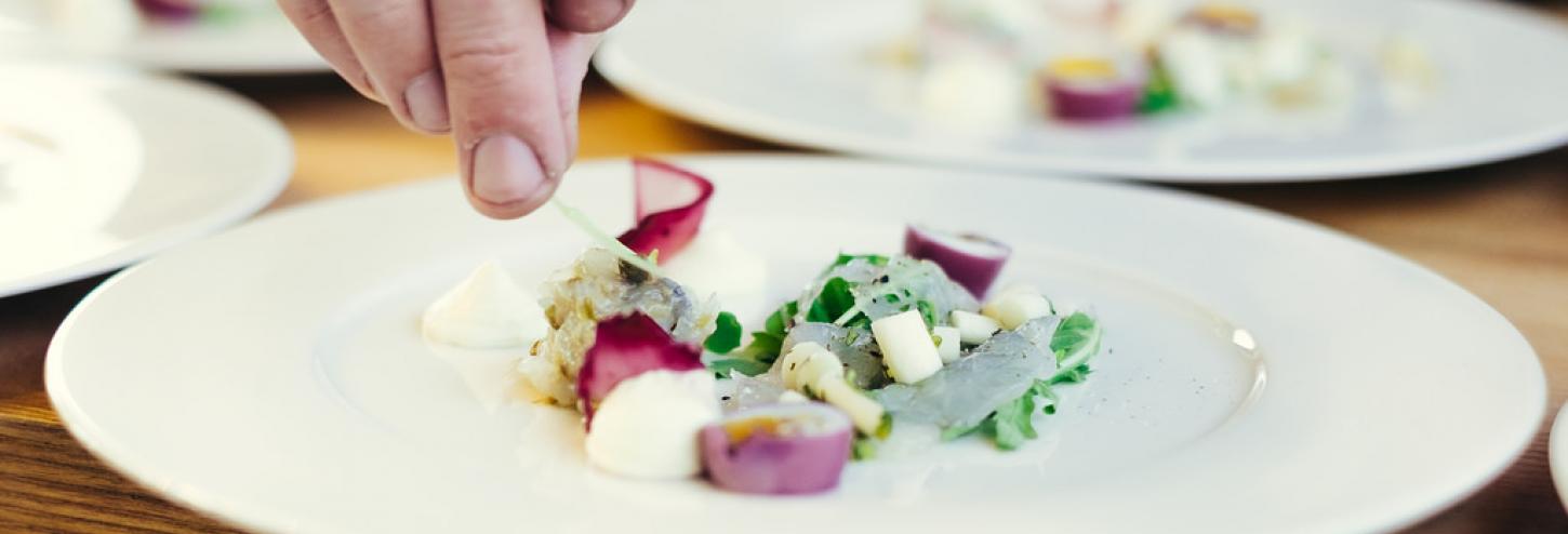 small colorful plate of food while chef is preparing