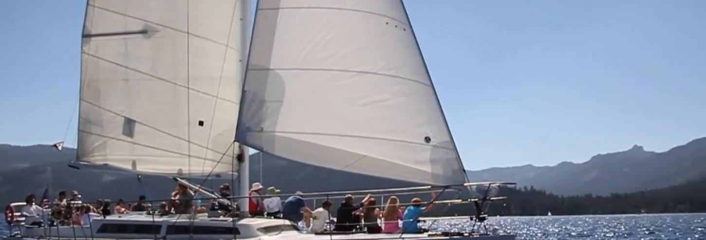 large group of people sailing in a boat on tahoe