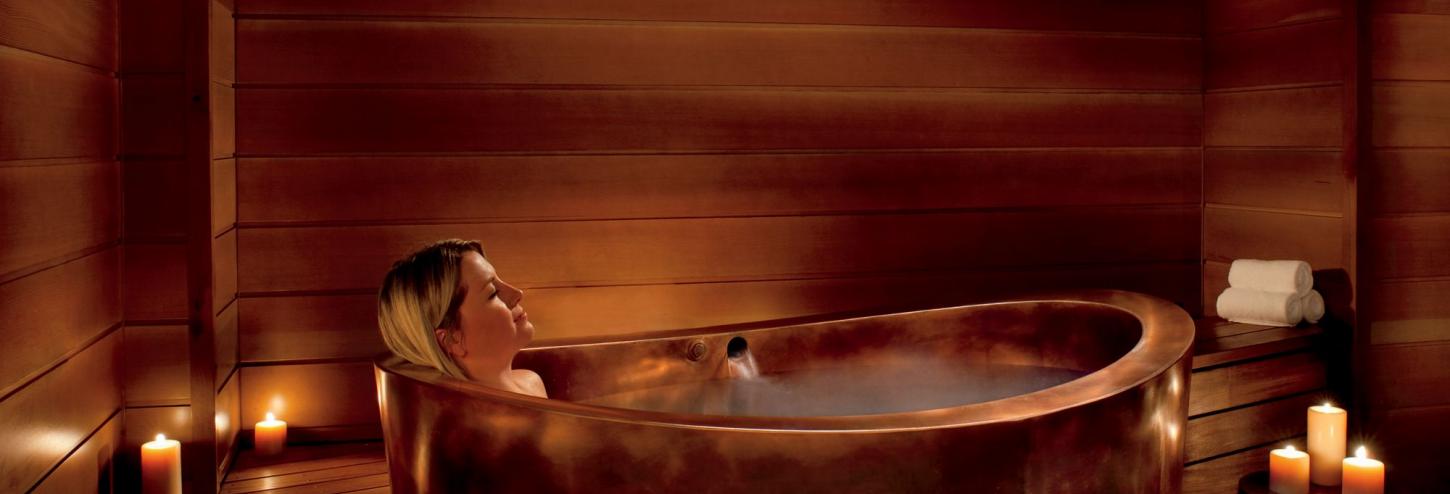 copper bathtub with woman in it