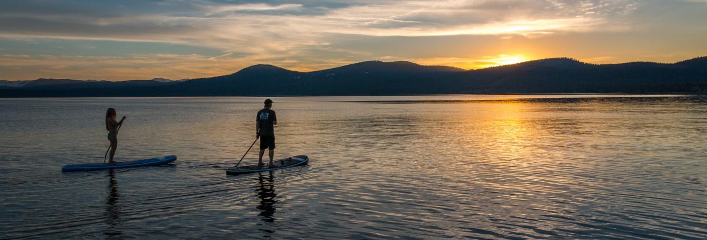 man going on a sunset paddleboarding trip