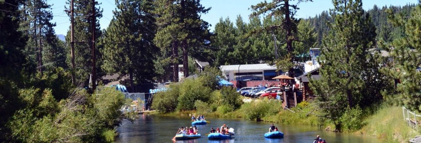 people on calm river floating in rafts