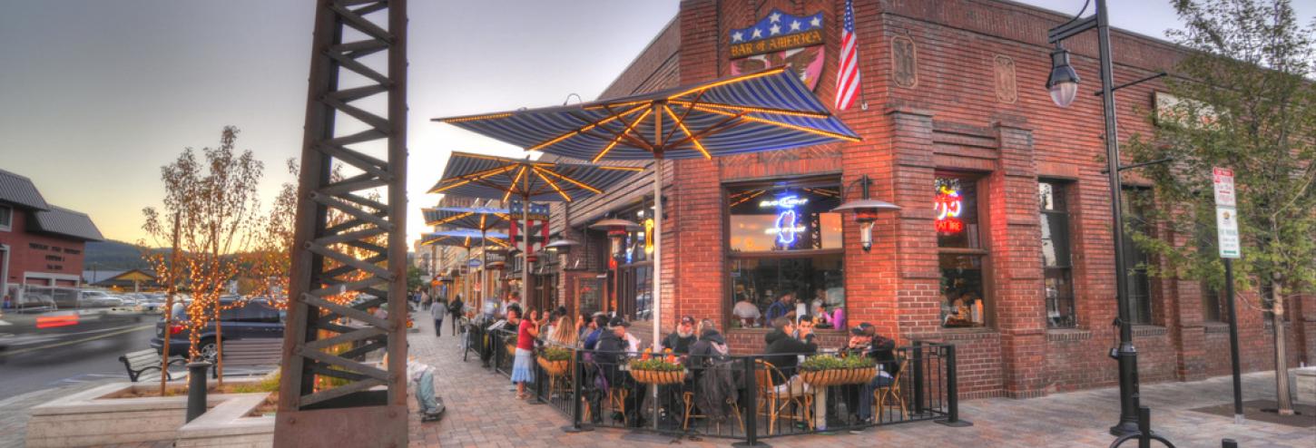 people eating outdoors at corner restaurant