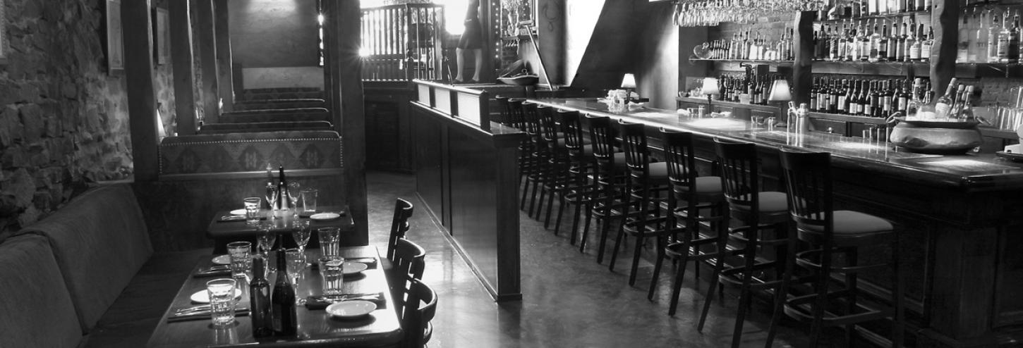 view of interior of restaurant wooden bar and tables