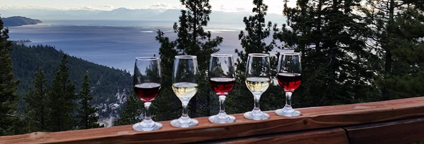 wine glasses on railing with view of lake