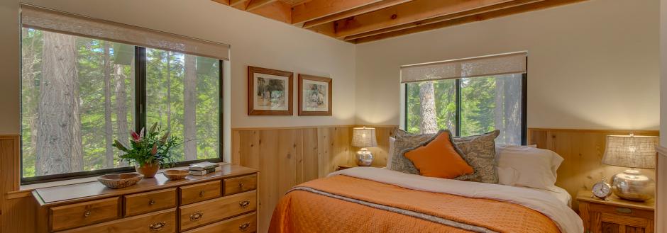 Bedroom with high ceilings and sunny windows