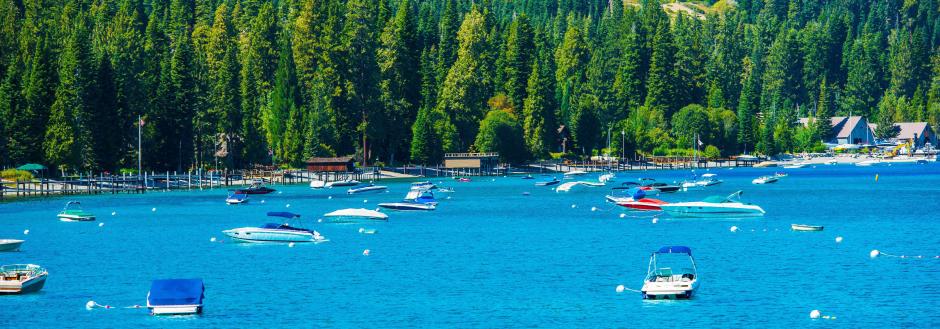 boats attached to buoys in lake tahoe waters