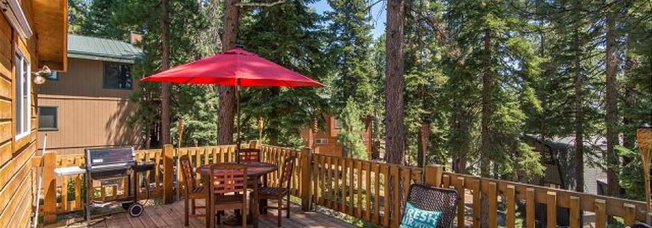 outdoor dining table with large red umbrella