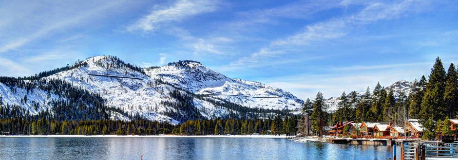 donner lake with snow capped mountains on the other side of the lake
