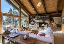 living room with large windows forecasting a view of the lake