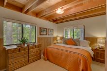 Bedroom with high ceilings and sunny windows