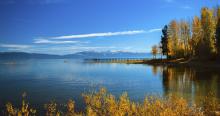 calm lake with fall colors on trees and bushes