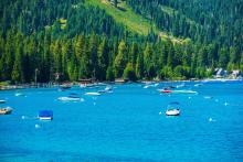 boats attached to buoys in lake tahoe waters