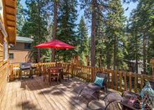 outdoor dining table with large red umbrella