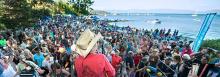 large gathering of people on the beach watching concert