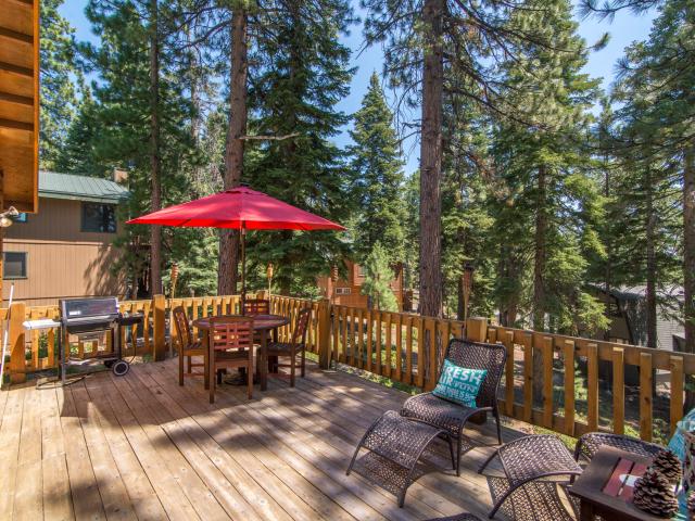 outdoor dining table with large red umbrella