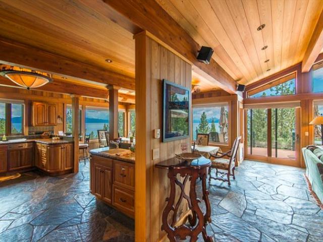 dining room looking out large windows toward lake