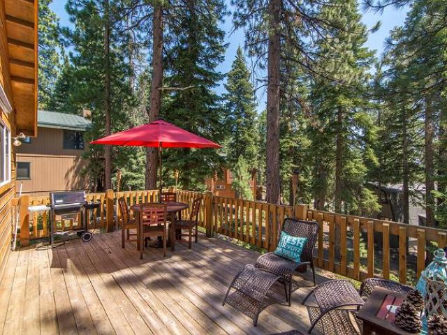 outdoor dining table with large red umbrella