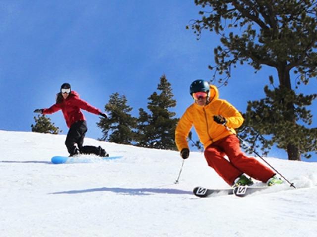two people skiing down the mountain