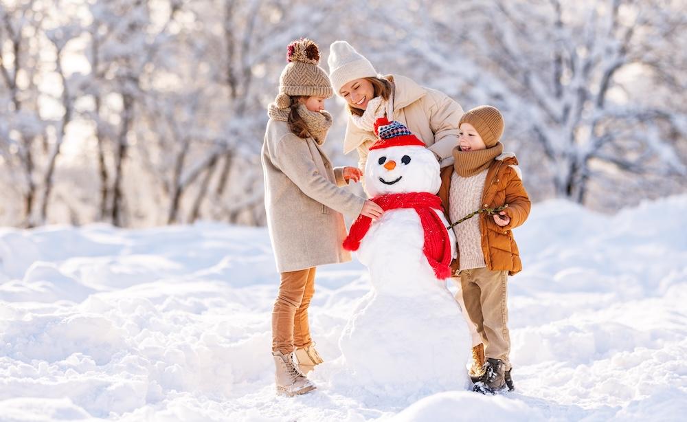 mother and children building a snowman