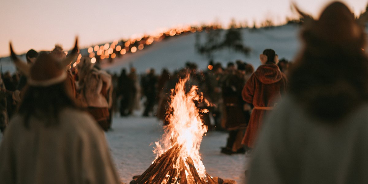 Ullr Fest at Diamond Peak Costumed revelers in horned helmets gathered around a bonfire on the snow at dusk