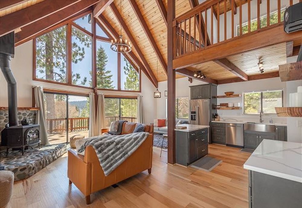 inside of large luxury rental in Lake Tahoe with floor to ceiling windows and vaulted ceilings